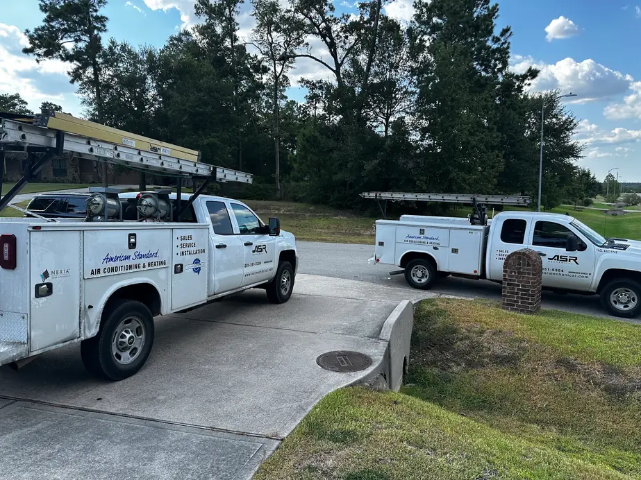 Two ASR Mechanical service trucks parked at a residential job